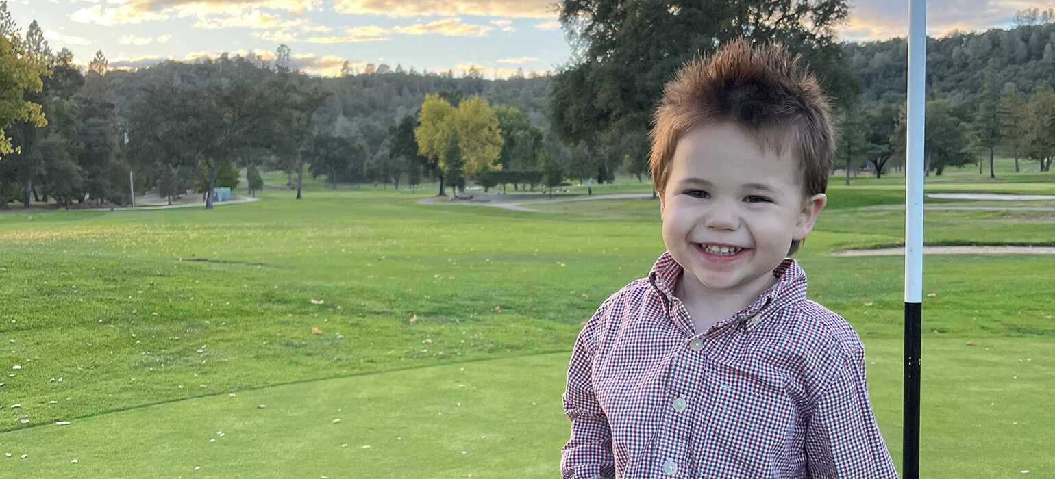 Young golfer on green